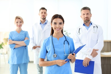 Medical assistant with colleagues in clinic. Health care service