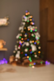 Photo of Blurred view of room with beautiful Christmas tree