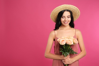 Photo of Portrait of smiling woman with beautiful bouquet on pink background. Space for text