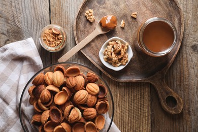 Making walnut shaped cookies. Cooked dough, caramelized condensed milk and nuts on wooden table, flat lay