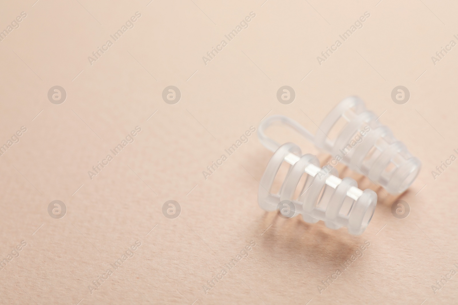 Photo of Nasal anti-snoring device on light background. Space for text