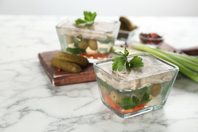 Delicious aspic with meat and vegetables served on white marble table