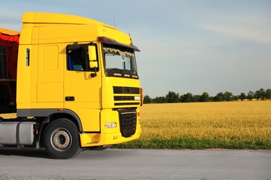 Photo of Modern truck on country road. Space for text