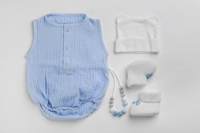 Flat lay composition with baby clothes and accessories on white background