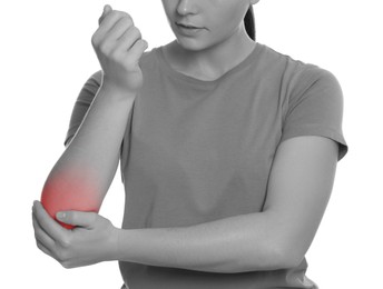 Woman suffering from pain in elbow, closeup. Black and white effect