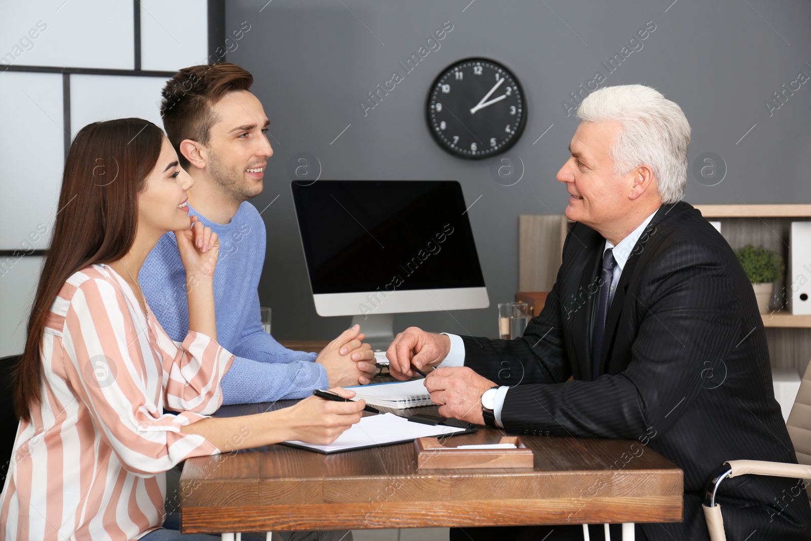 Photo of Lawyer having meeting with young couple in office