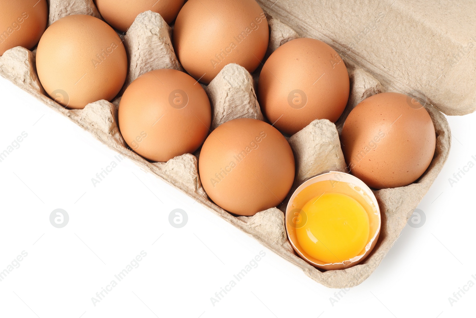 Photo of Chicken eggs in carton isolated on white, top view