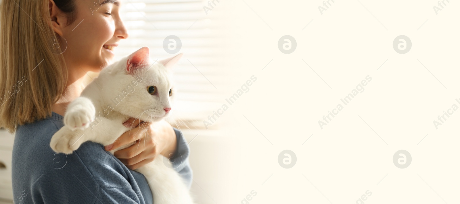 Image of Young woman with her beautiful pet at home, space for text. Banner design