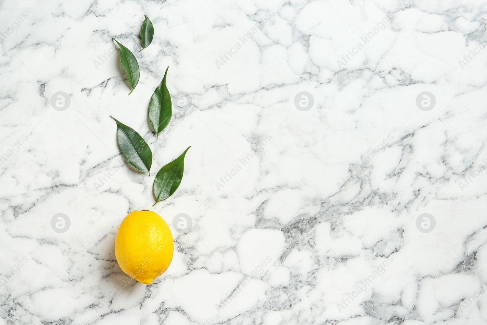 Photo of Flat lay composition with lemon and leaves on marble background