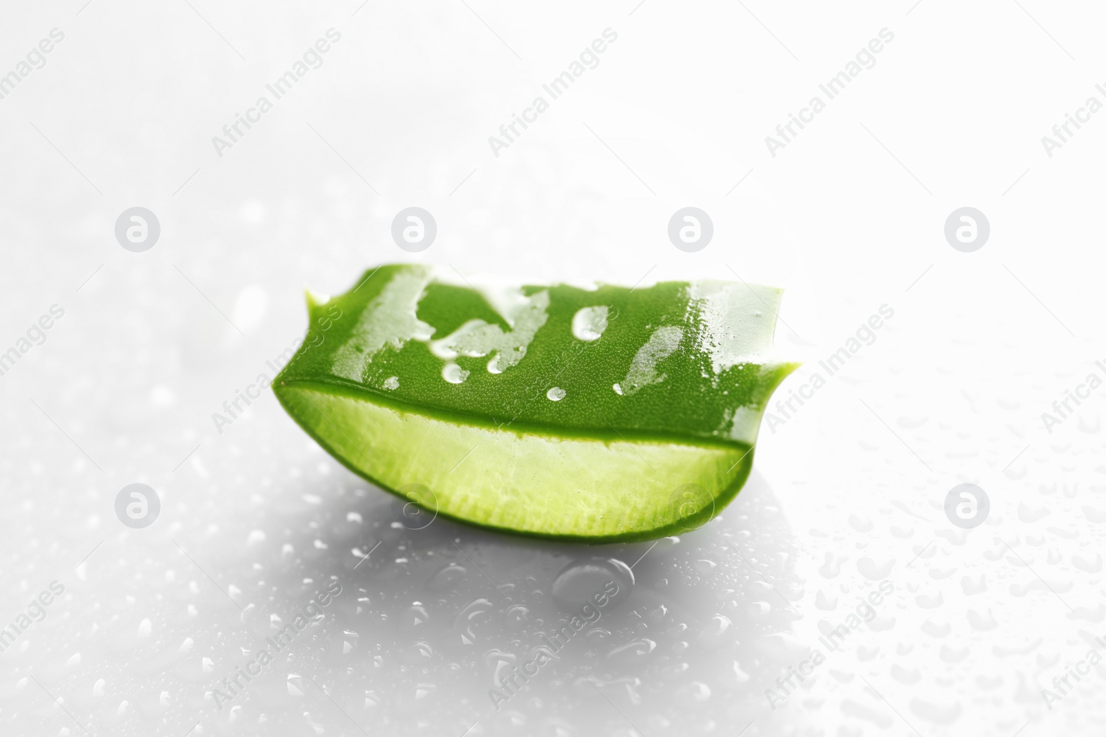 Photo of Slice of aloe vera on white background, closeup