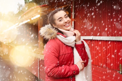 Image of Happy young woman at winter fair. Christmas celebration