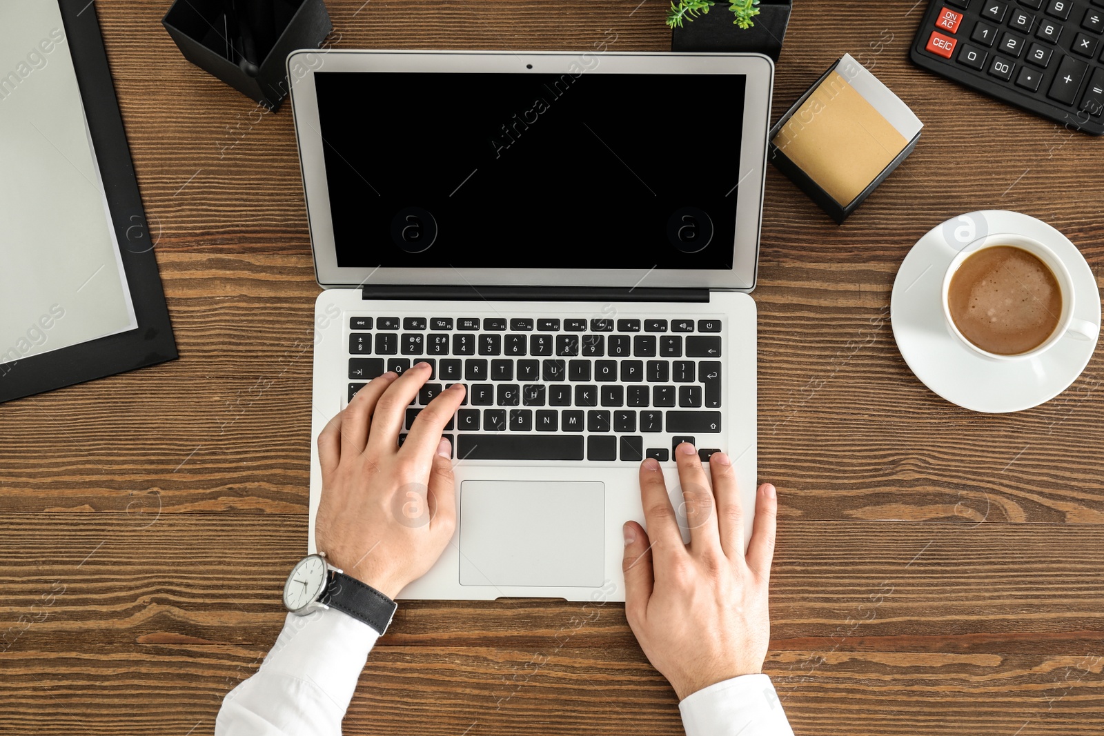 Photo of Man using laptop at table, top view. Space for design