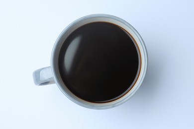 Mug of freshly brewed hot coffee on white background, top view