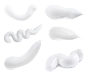 Image of Set with smears of toothpaste on white background