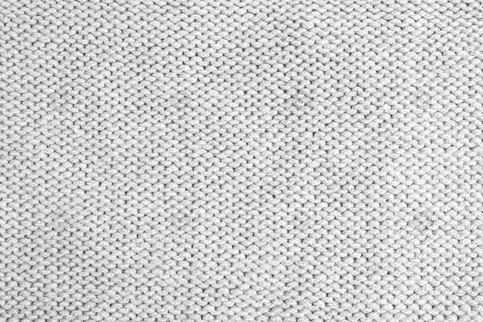 Photo of Grey knitted sweater as background, closeup view