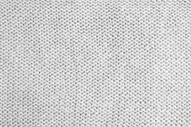 Photo of Grey knitted sweater as background, closeup view