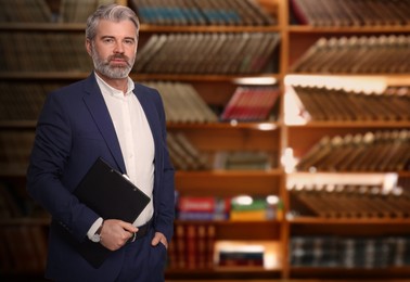 Lawyer with clipboard against shelves with books, space for text