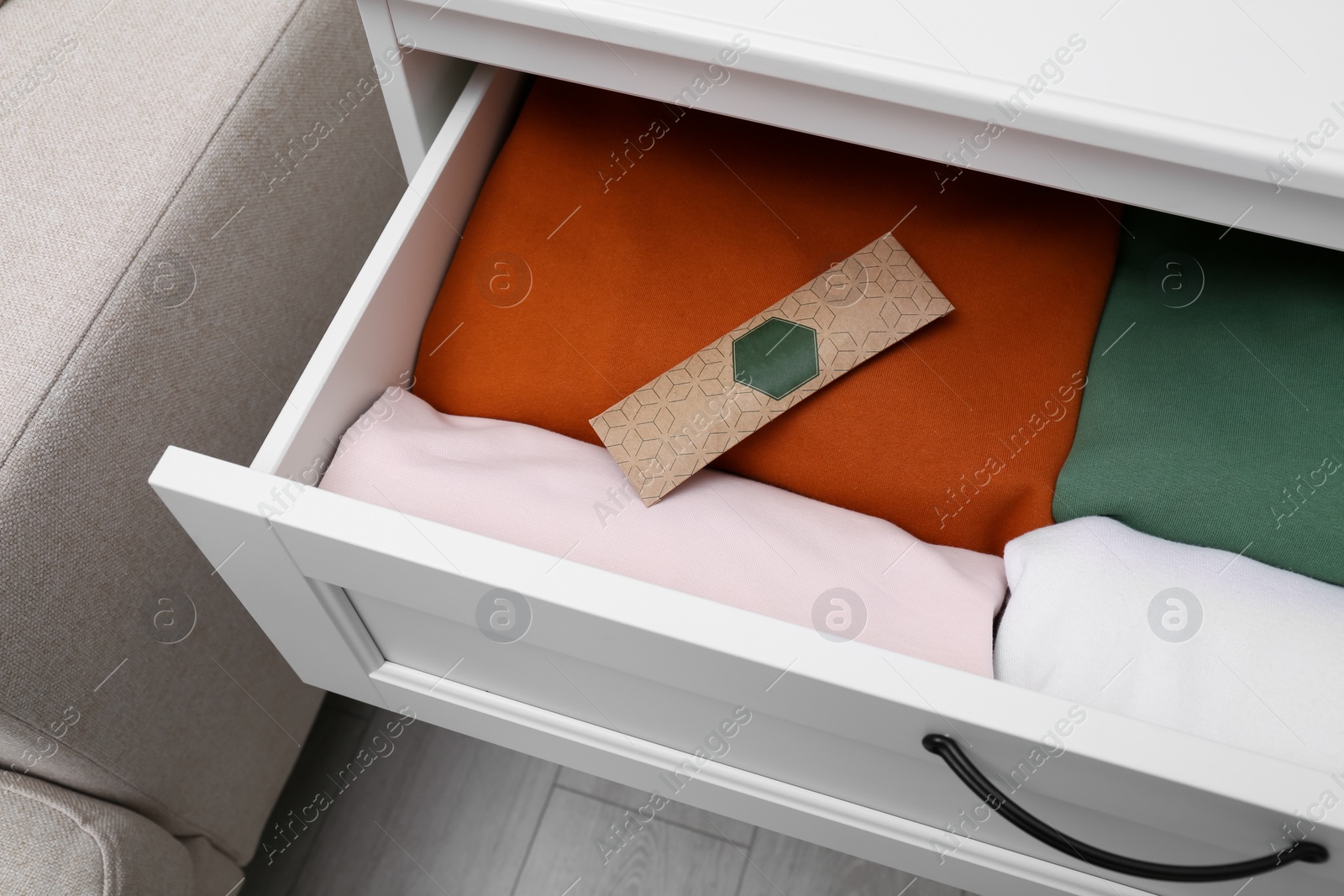 Photo of Scented sachet and folded clothes in drawer