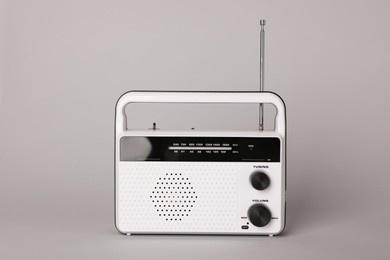 Photo of Portable retro radio receiver on grey background