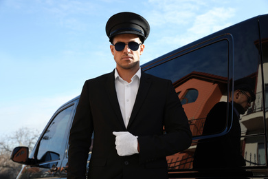 Photo of Professional driver near luxury car. Chauffeur service