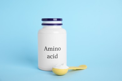 Amino acid powder on light blue background
