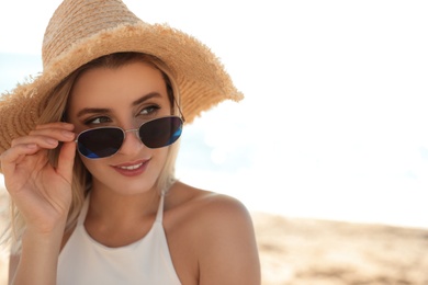 Photo of Beautiful woman wearing sunglasses outdoors on sunny day