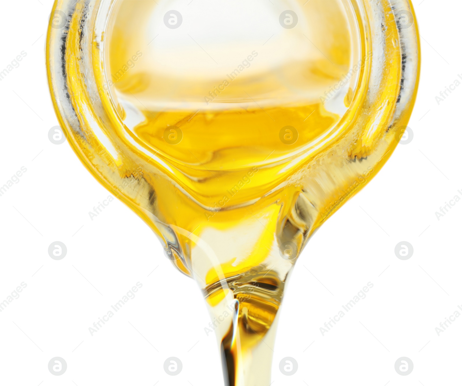 Photo of Pouring cooking oil from pitcher isolated on white