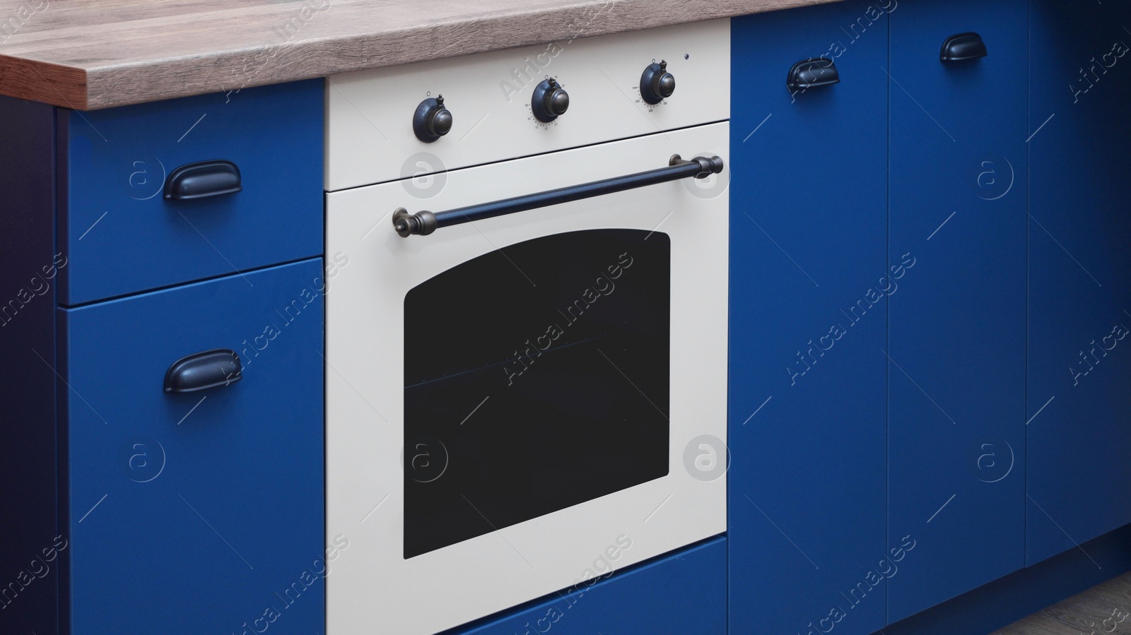 Photo of New stylish oven in kitchen. Cooking appliance