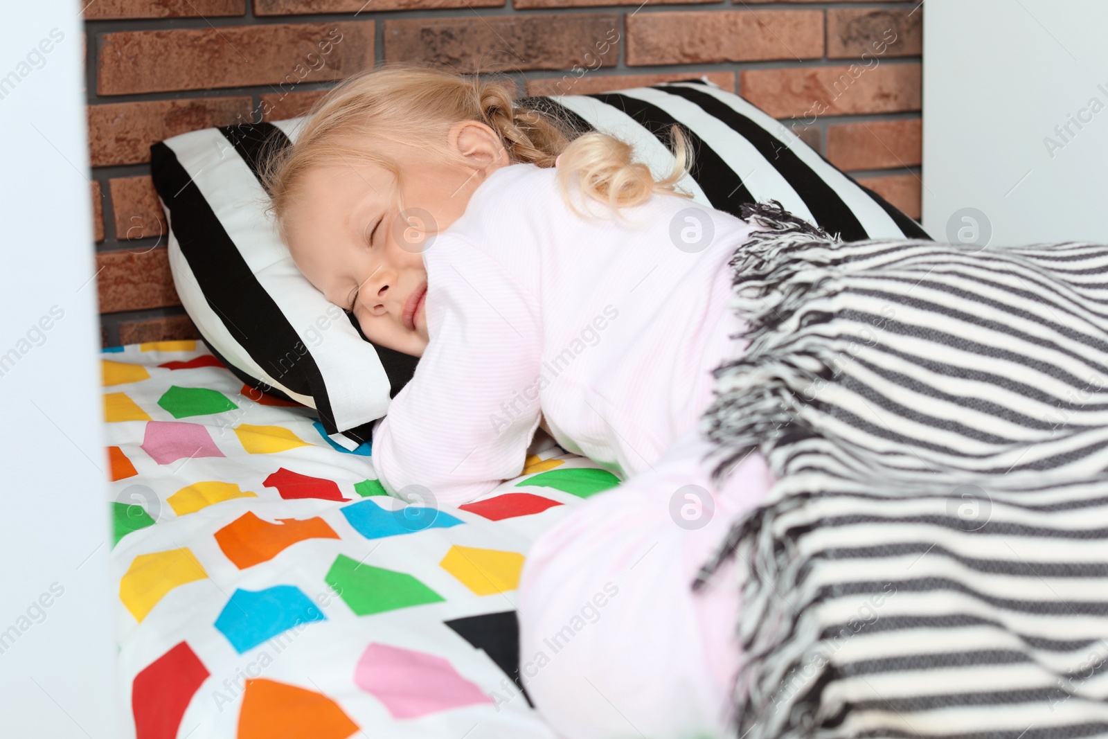 Photo of Cute little girl sleeping in bed at home