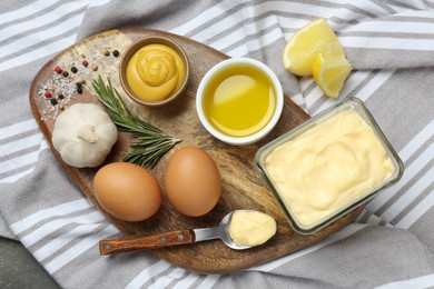 Delicious homemade mayonnaise, spices and ingredients on napkin, top view