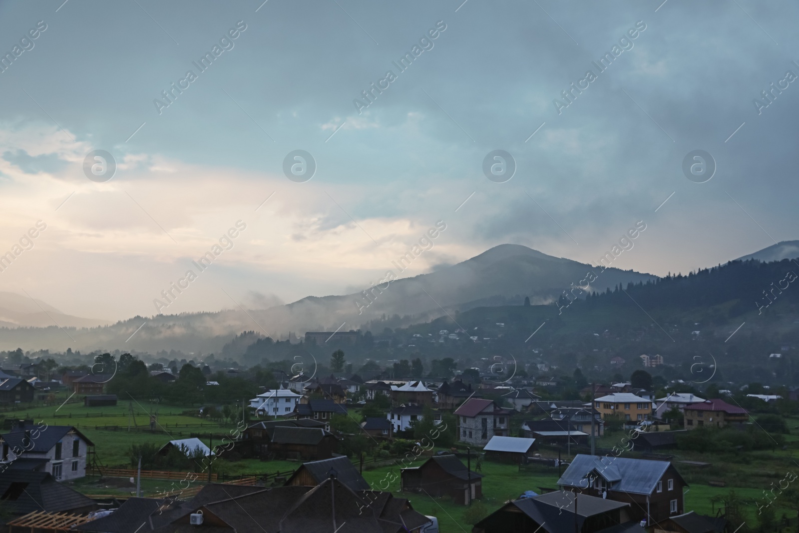 Photo of Picturesque view of mountain village with fog