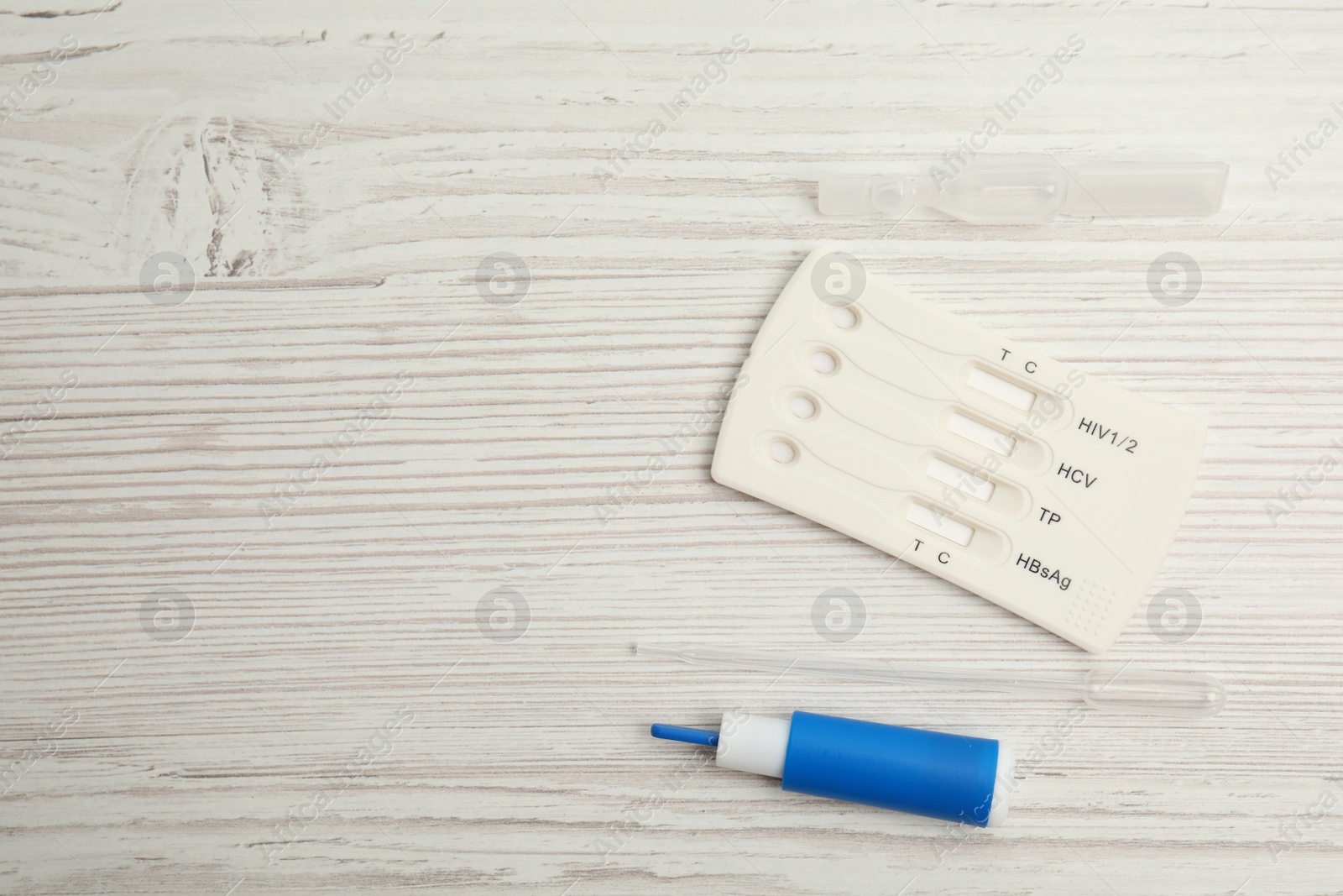 Photo of Disposable express hepatitis test kit on white wooden table, flat lay. Space for text