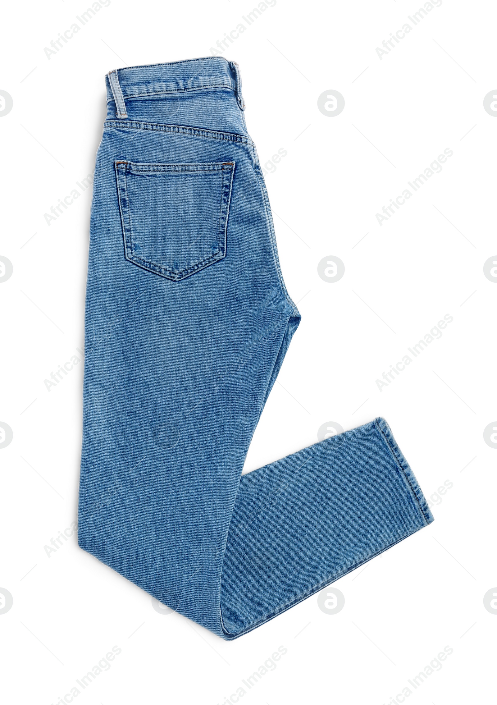 Photo of Light blue jeans isolated on white, top view. Stylish clothes