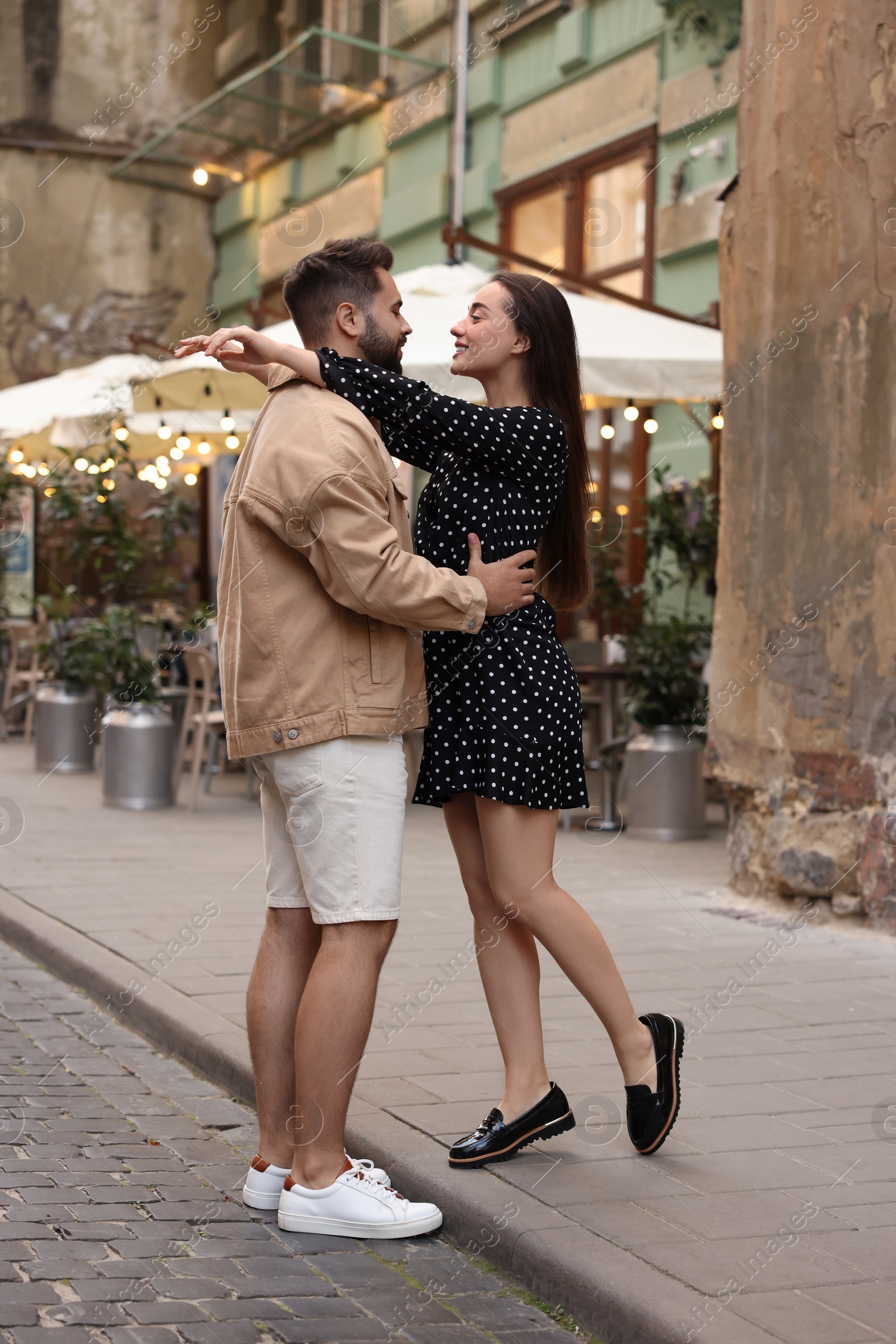 Photo of Lovely couple dancing together on city street