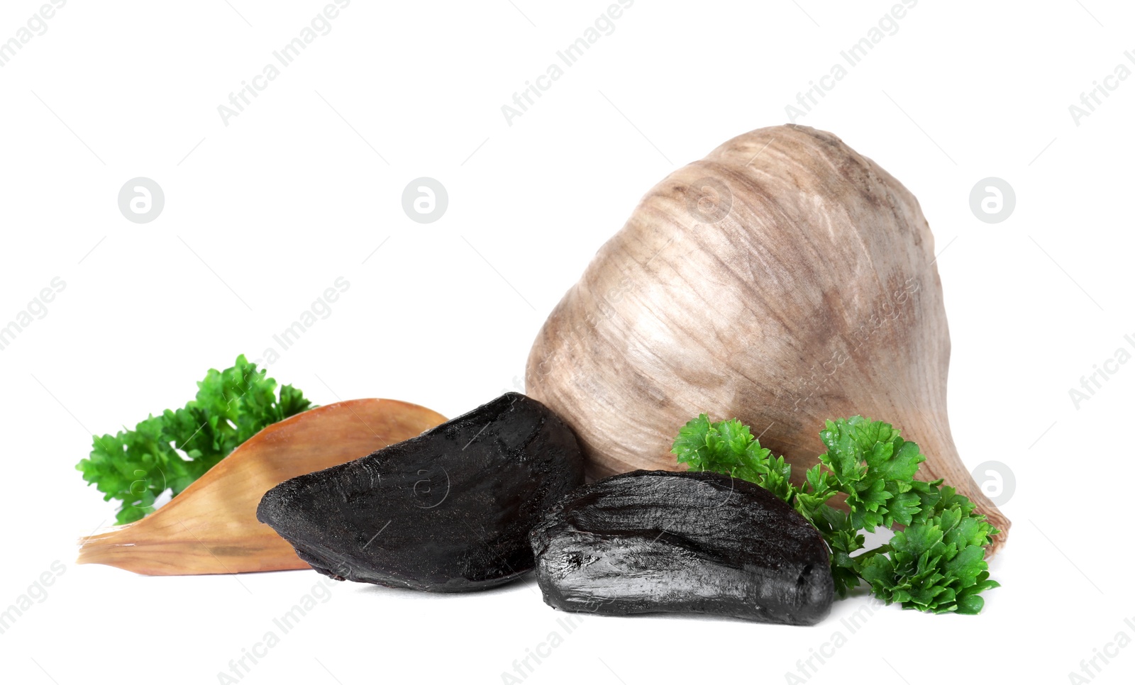 Photo of Aged black garlic with parsley on white background
