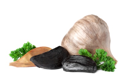 Aged black garlic with parsley on white background
