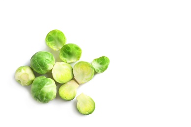 Photo of Fresh Brussels sprouts and leaves on white background, top view