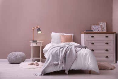 Photo of Cozy bed with soft linens in light room