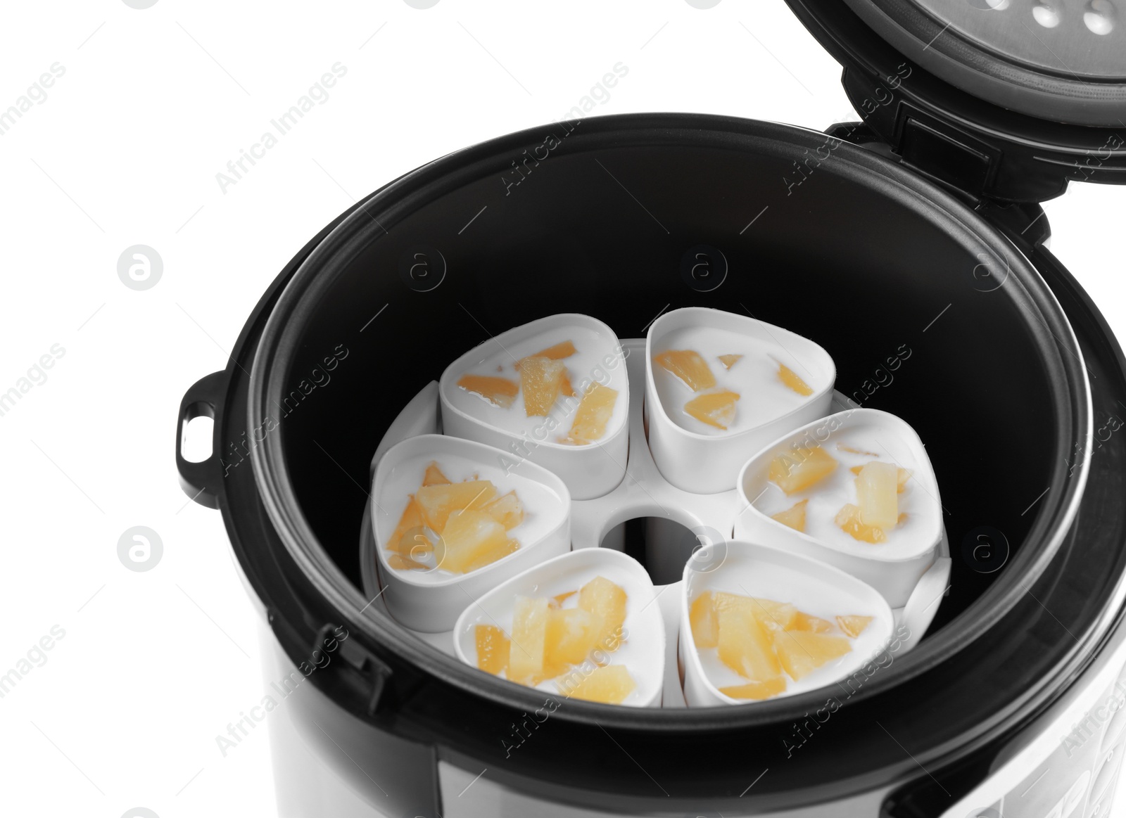 Photo of Cups of pineapple yogurt in multi cooker on white background, closeup