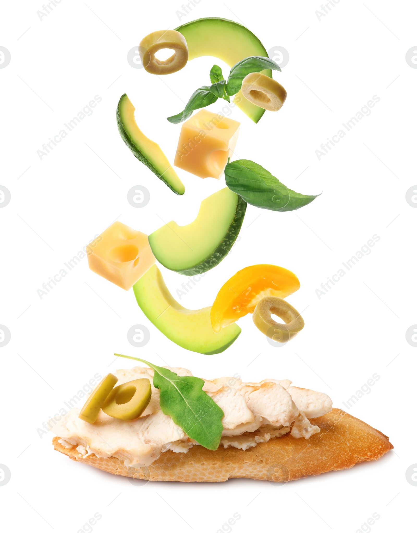 Tasty bruschetta with flying ingredients on white background Image of Tasty bruschetta with flying ingredients on white background