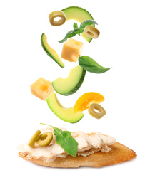 Image of Tasty bruschetta with flying ingredients on white background