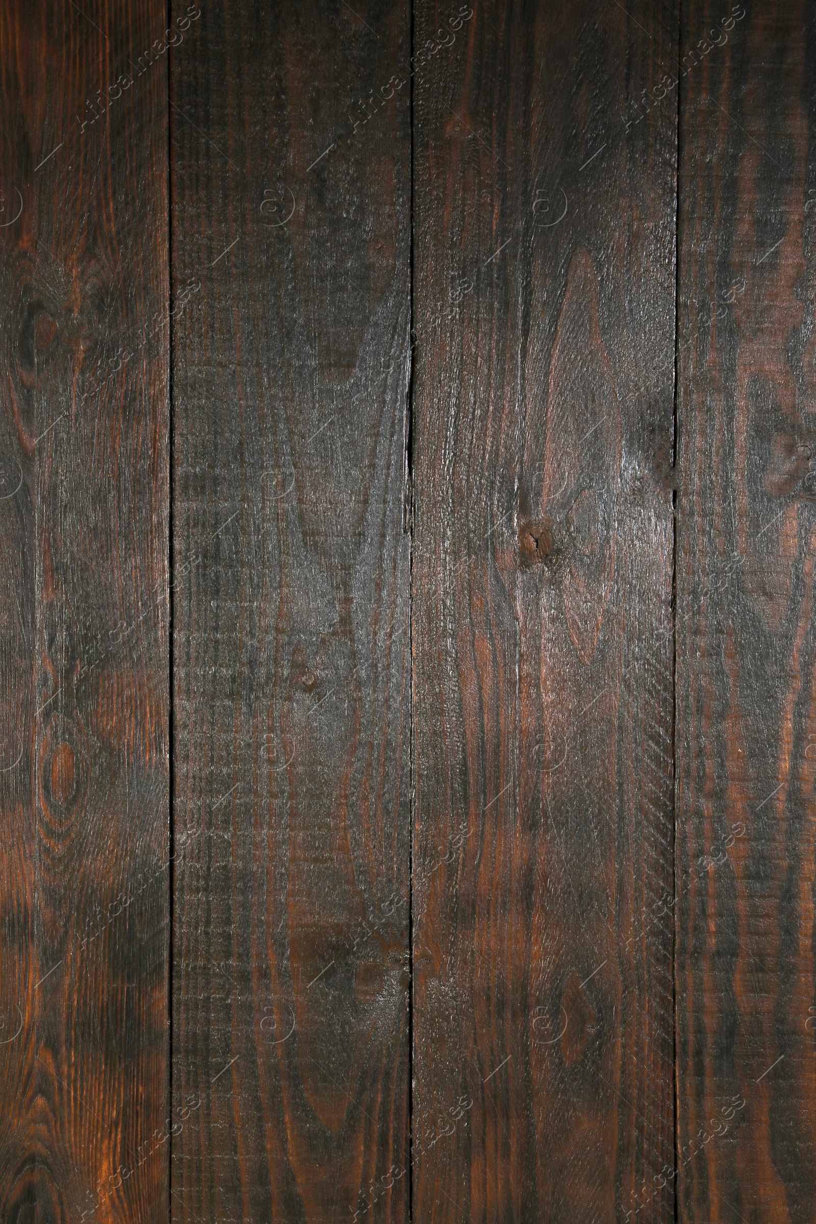 Photo of Texture of dark brown wooden surface as background, closeup