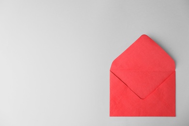 Red paper envelope on light background, top view. Space for text