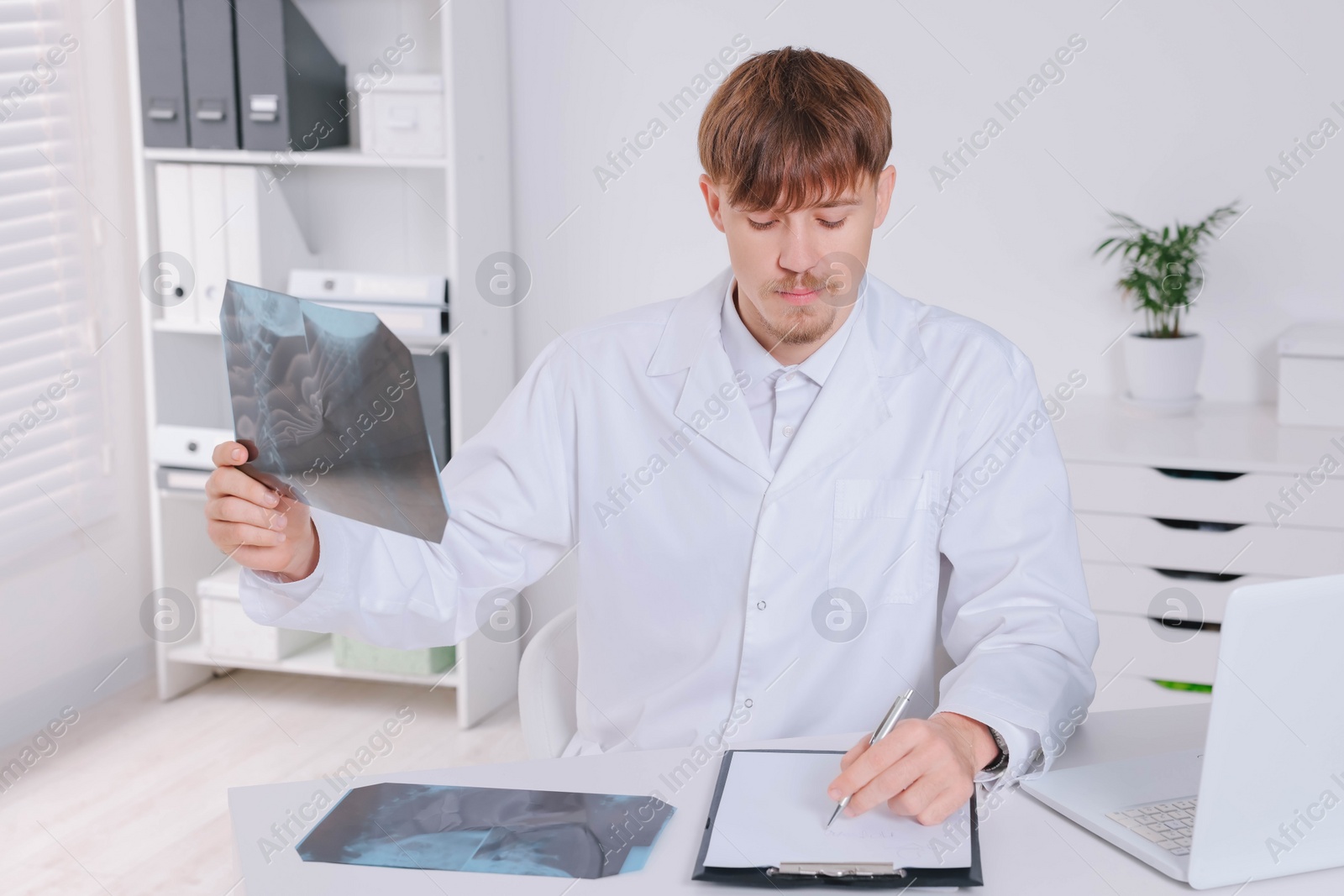 Photo of Doctor examining neck MRI image in clinic