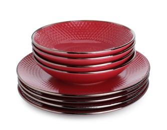 Photo of Stack of red bowls and plates isolated on white