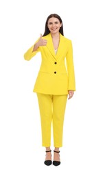 Photo of Beautiful happy businesswoman in yellow suit showing thumbs up on white background