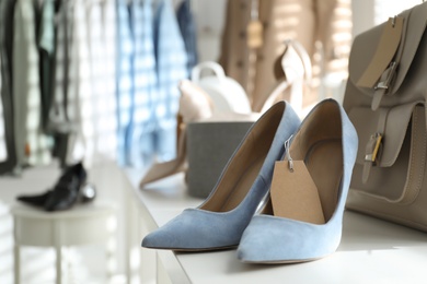 Photo of Women's high heel shoes and accessories in modern clothing boutique, space for text