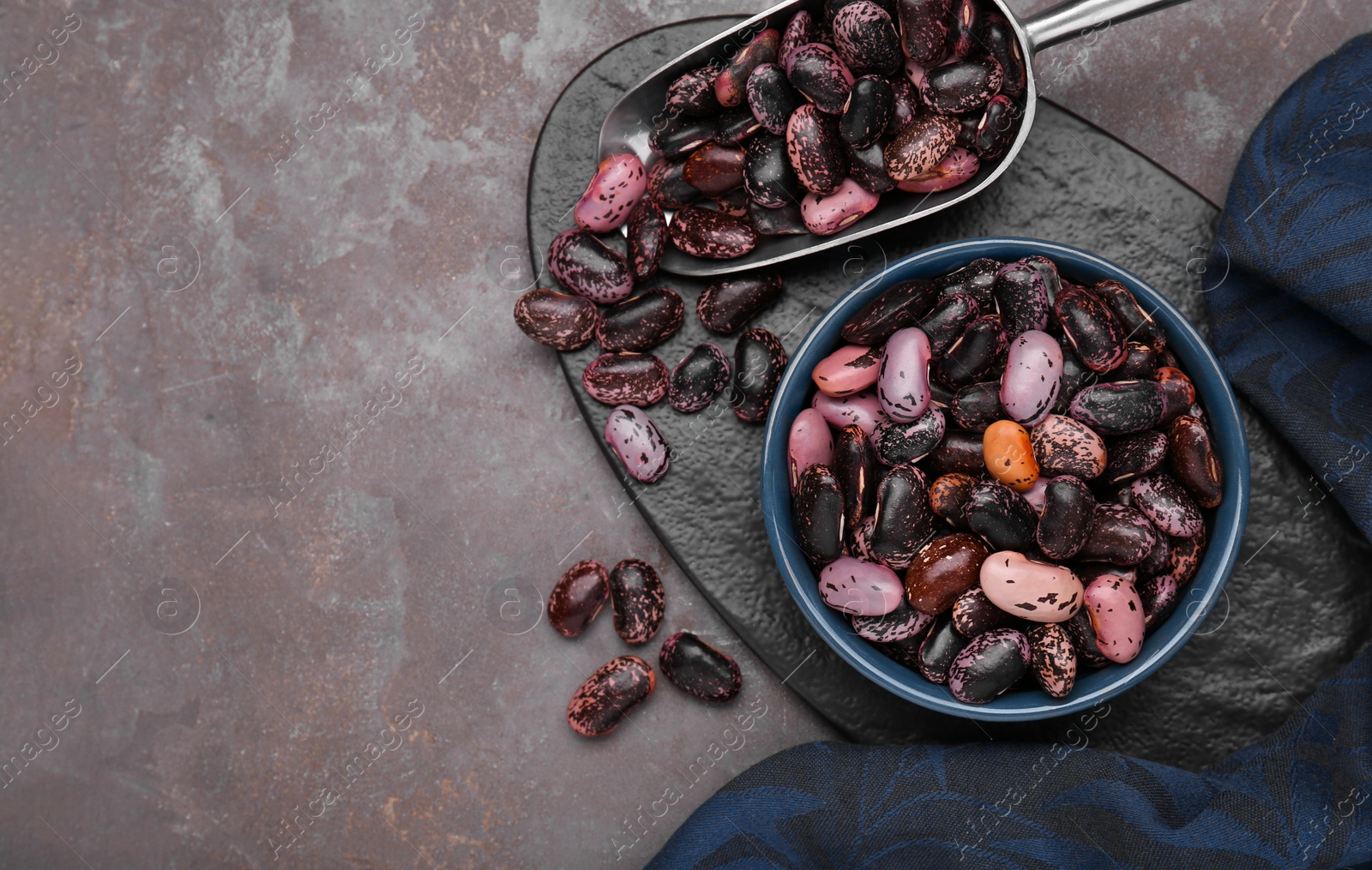 Photo of Many dry kidney beans on grey table, flat lay. Space for text