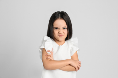 Photo of Portrait of cute little girl on light grey background