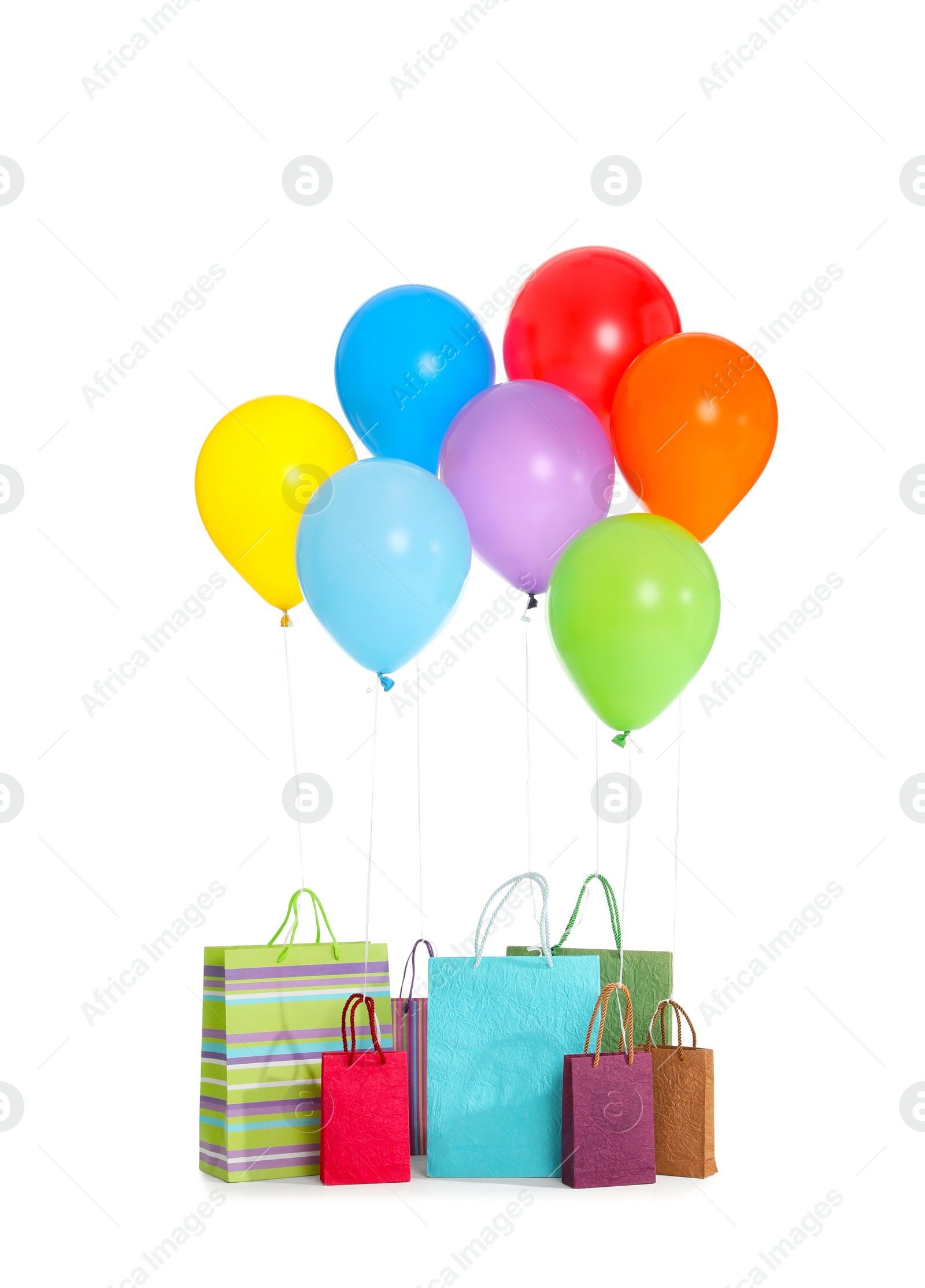 Photo of Paper bags with bright air balloons on white background